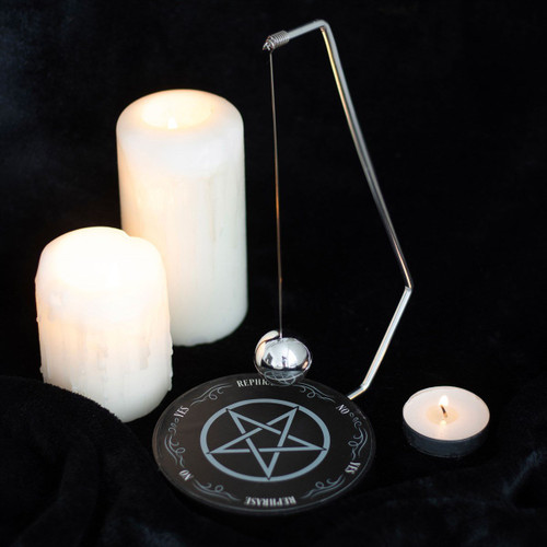 Pendulum Decision Maker
Featuring a mystical pentagram design, this metal decision-making tool incorporates a spherical pendulum that seemingly selects one of six responses at random. Simply pose your 'yes' or 'no' question and observe as the pendulum moves through the possible outcomes, ultimately landing on a result. Its compact size makes it ideal for placement on desktops or side tables, offering quick and convenient decision-making assistance.

Product Dimensions: H21cm x W14.5cm x D10cm