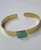 Brass Bangle Hammered Amazonite

This brass and gemstone cuff bangle features a wide, flat band with a hammered texture that provides a rustic, handcrafted finish and the open-back design allows for an adjustable fit.  

Brass is an alloy; it is a beautiful blend of copper and zinc, and it is nickel-free.
It possesses a natural, earthy yellow hue that looks remarkably like solid gold without the price!

All our brass jewelry is handmade in Rajasthan in North India