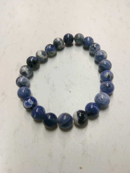 Power Bracelet Sodalite
Sodalite offers a gentle soothing quality which can increase insight, intuition and mental abilities. It is useful as a stone for creative expression, assisting in finding one’s creative voice. Wisdom, logic, calmness, healing, stress reduction, companionship, self-esteem, work in groups, heal communication breeches, truth, intelligence, knowledge, learning. Use for glands, digestive system, insomnia, calcium deficiency, head colds.