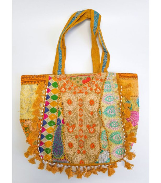 Embroider Patch Tote Mustard
This colourful, large cotton tote bag made in India is beautifully adorned with intricate embroidery and playful tassels, showcasing traditional craftsmanship. It is spacious and perfect for carrying everything you need for daily use or a weekend getaway.

- The base colour will be as shown in images, however the designs and patterns will vary, allowing each piece to be unique.

- 1 main zip compartment and 1 inner zip compartment

Dimensions when flat as shown in flat lay images:

- Width: 53cm approx

- Length: 40cm approx