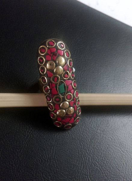 Tibetan Red Coral Ringwith green torquoiseinserts. This lovely ring is set in brass & has an adjustable band.