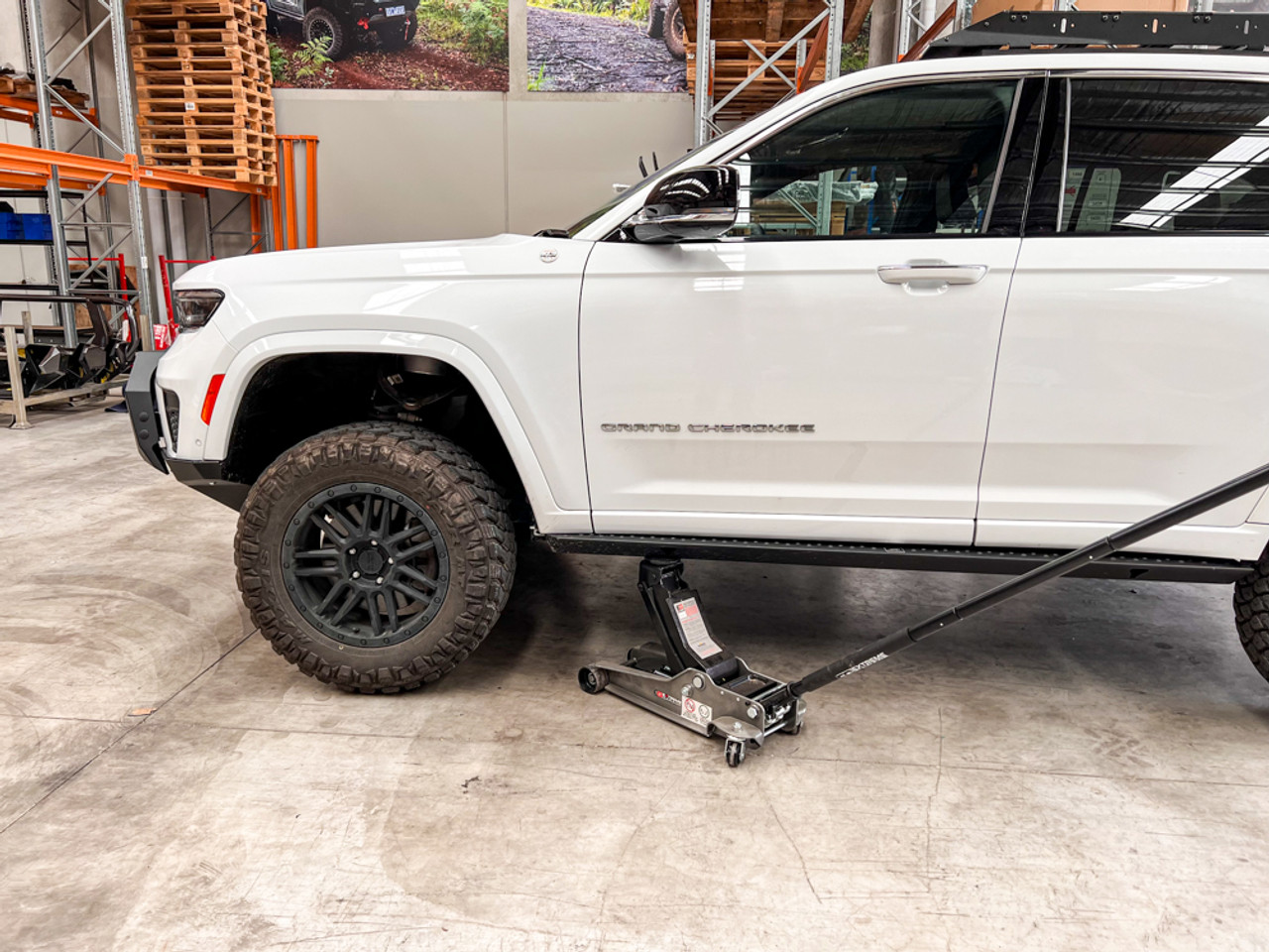 WL Grand Cherokee Rock Sliders lifting vehicle with jack