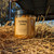 Turmeric Ginger Glow Scrub against on top of a hay bale.