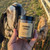 Coffee Rosehip Sugar Scrub being held out in front of Commando, the goat.