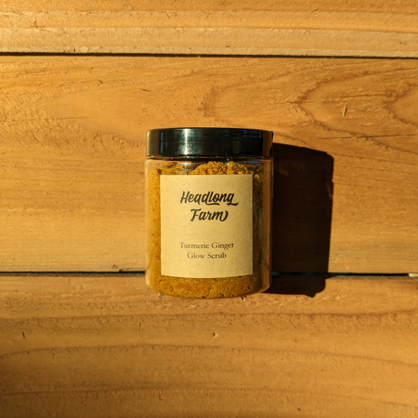 Turmeric Ginger Glow Scrub against a wood pallet background.