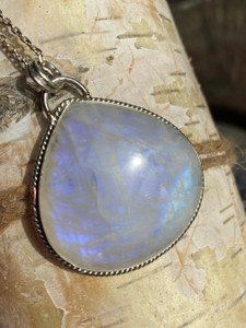"Moonstone pendant necklace adorned in sterling silver, radiating a captivating blue spectrum hue." "Moonstone pendant necklace adorned in sterling silver, radiating a captivating blue spectrum hue."