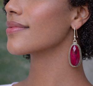 Ruby gemstone dangle earrings featuring pink stones in bezel set sterling silver statement design