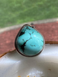"Genuine turquoise gemstone set in sterling silver 925 ring with a pear-shaped design." "Genuine turquoise gemstone set in sterling silver 925 ring with a pear-shaped design."