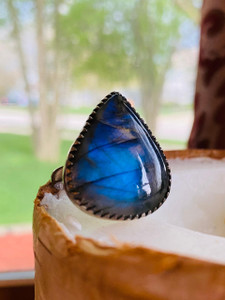 "Adjustable women's ring showcasing a mesmerizing Labradorite gemstone in a bezel setting." "Adjustable women's ring showcasing a mesmerizing Labradorite gemstone in a bezel setting."