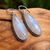 Long dangly moonstone earrings featuring faceted pear shaped gemstones in sterling silver