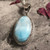 "Larimar pendant necklace with Tibetan design, invoking inner wisdom and manifestation." "Larimar pendant necklace with Tibetan design, invoking inner wisdom and manifestation."