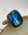 "Adjustable men women's ring adorned with a captivating Labradorite gemstone, handcrafted for elegance." "Adjustable men women's ring adorned with a captivating Labradorite gemstone, handcrafted for elegance."