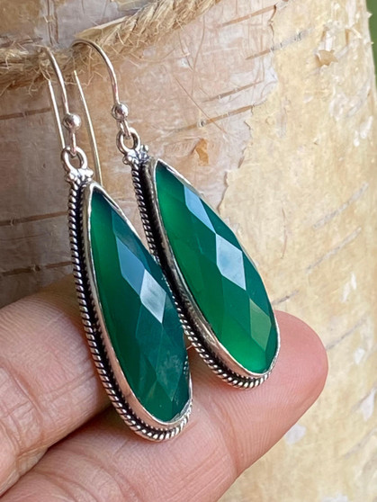 "Enhance your ensemble with these Earthkarma long Green Onyx teardrop earrings. Shop now and add a touch of elegance to your look!"