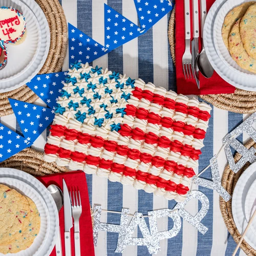 American Flag Sheet Cake with hand-piped red, white, and blue buttercream displayed as the centerpiece of a 4th of July dessert table View 2