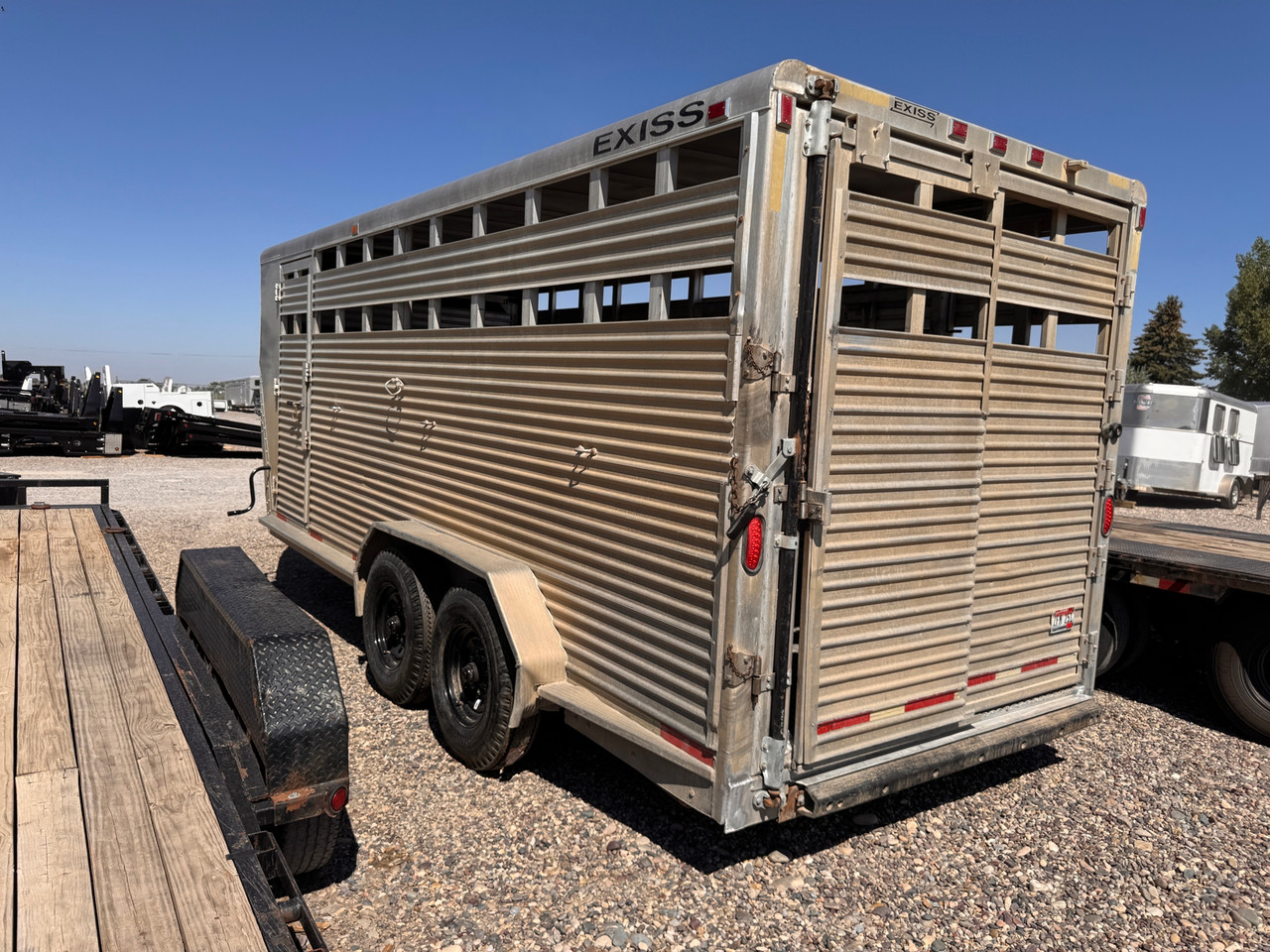 Exiss Trailers 1997 18' Stock Trailer | Tandem Axle Axle 14K, Spare Tire, Drivers Side Escape Door, Rear Swing Door with Sliding Gate, Over Tongue Storage