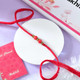 Red Pearl Rakhi with Cadbury Dairy Milk Assorted Gift Box
