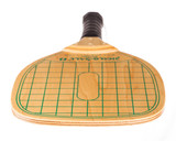 Swinger Pickleball Paddle-durable wood paddle with green checkerboard design, black handle wrap and wrist strap.