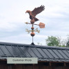 Customer photo of large Eagle Weathervane side view on gray sky background.