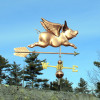 Flying Pig Weathervane right side view on blue sky background.