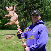 Dancing Pig Weathervane being held by Todd