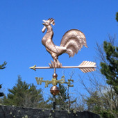 Crowing Rooster Weathervane left side view on blue sky background