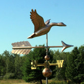 Flying Goose with Arrow Weathervane right angle view on blue sky background