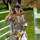 Jamey holding a custom initial copper banner weathervane for size reference