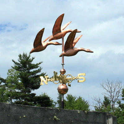 Three Geese Weathervane right side view on blue and cloudy sky background