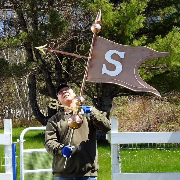 Todd holding Grand Fancy Banner Weathervane with S Initial