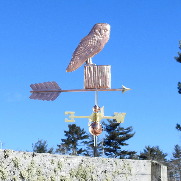 barn owl weathervane on a post