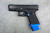 Close-up angle of Glock 19 Gen 5 frame with blue Cross Armory kit installed — magwell fitment and pin set