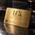 Brushed gold metal business card with textured grain and engraved branding