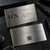 Professional metal business card being handed to a customer in a business setting