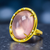 This handcrafted rose quartz ring radiates feminine energy, enhanced with a brilliant diamond halo and a smooth 18k white gold setting.