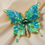 This exquisite butterfly brooch showcases the rare and intricate plique-à-jour enameling technique, allowing light to pass through the translucent wings like stained glass. With an 18K gold frame, Tahitian pearl center, and diamond and sapphire accents, it's both delicate and dramatic.