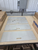 Four HMS stainless steel setup plate floor protectors laid out on a table