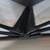 Interior hinge detail of stitched 6-panel 8.5x11 restaurant menu cover showing layered clear PVC page sleeves and leatherette binding.