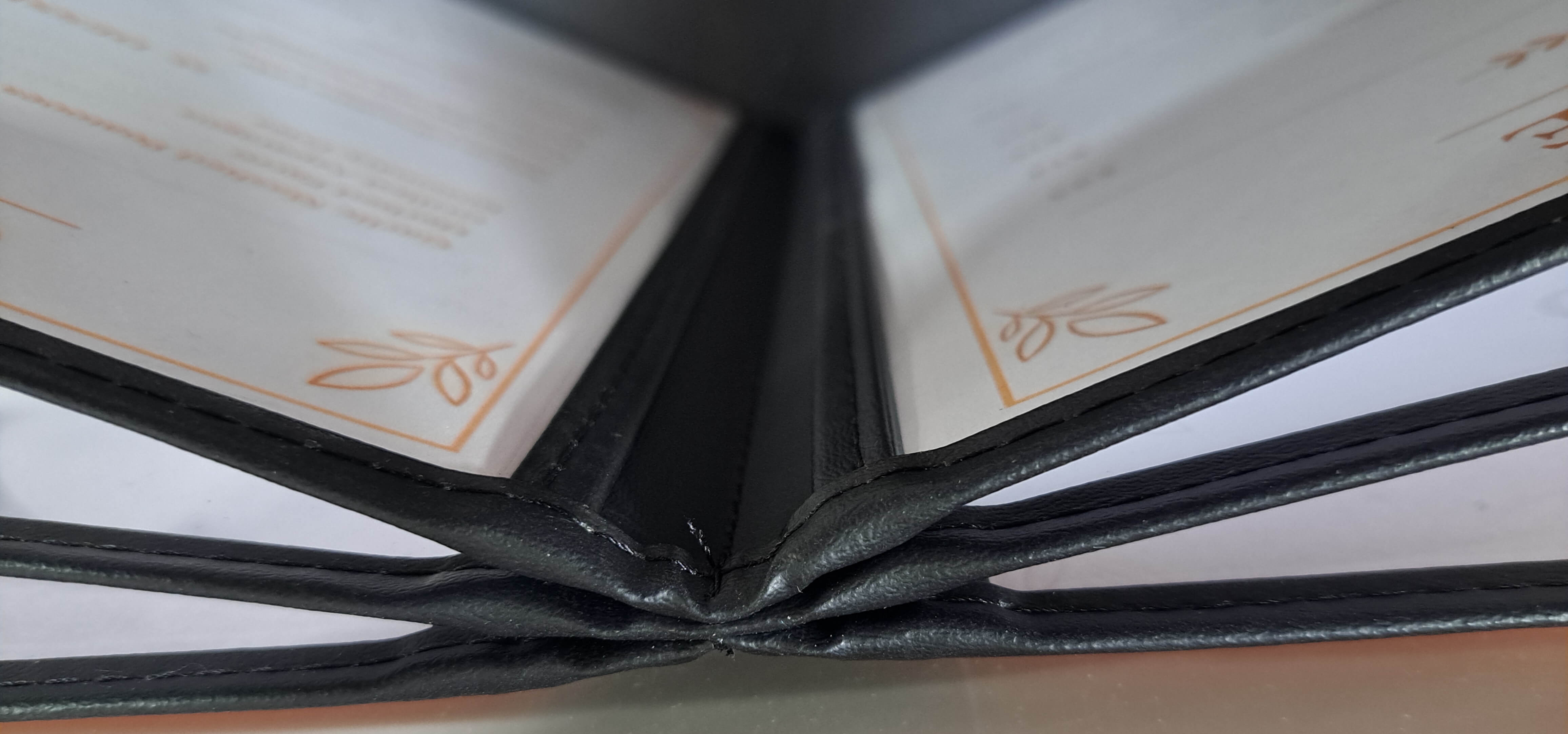 Interior spine construction of 6-panel stitched restaurant menu cover