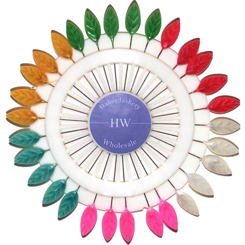 One pin wheel laying flat showing the leaf shaped headed pins which are pearlised and consist of 5 x each of pink, white, red, green, yellow, blue, and are house in a white plastic wheel