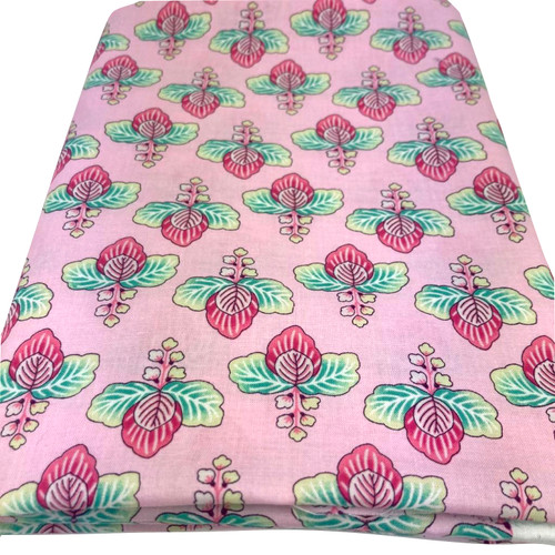 Image shows a medium weight light pink cotton fabric, 137cm wide, printed with a colourful floral design featuring large flowers and leafy shapes resembling cabbage leaves. The design is uniform with no set direction. Folded in a rectangle.