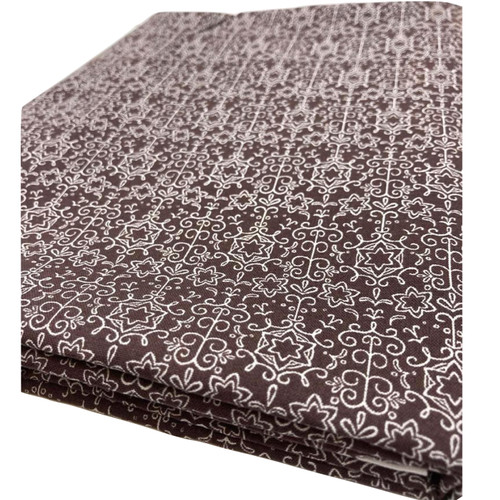 Image shows a brown 100% cotton fabric printed with white snowflake stars in a repeating scattered pattern. The fabric is 137cm wide with a smooth, medium-weight folded in a rectangle photographed from an angle.