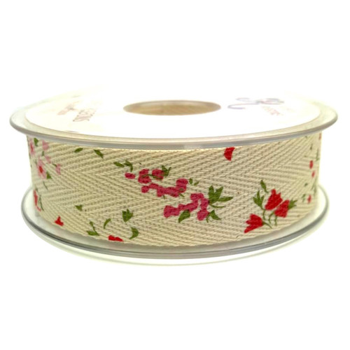 A spool of cream coloured woven ribbon tape with a printed pattern of pink and red flowers with green foliage.