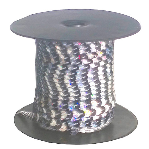 Alternating black and white sequins each 6mm diameter, pre-strung on thread, shown on a roll.