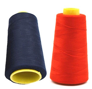 Image shows two large 5000 yard cones of superior polyester sewing thread. The cones are tightly wound with smooth, durable polyester thread suitable for sewing machines and overlockers. Navy Blue and Red showing.