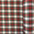 Image shows a length of Snowdon tartan polyester fabric, 150cm wide, in a medium-weight weave. The pattern features a classic tartan check in traditional colours with crisp, clean lines. The fabric has a smooth texture and moderate drape.
