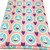 Image shows a lightweight cotton poplin fabric, 147cm wide, with a repeating pattern of happy bunnies and pink dots, purple hearts. The fabric has a smooth, fine weave and a soft drape. The image shows the fabric folded in a rectangle.