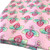 Image shows a medium weight light pink cotton fabric, 137cm wide, printed with a colourful floral design featuring large flowers and leafy shapes resembling cabbage leaves. The design is uniform with no set direction. Folded in a rectangle shown at an angle.
