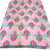 Image shows a medium weight light pink cotton fabric, 137cm wide, printed with a colourful floral design featuring large flowers and leafy shapes resembling cabbage leaves. The design is uniform with no set direction. Folded in a rectangle.
