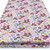 Image shows a sky-blue polycotton fabric printed with small, colourful flowers in various shades. The pattern is evenly scattered, creating a fresh, summery look. The fabric is 112cm wide with a smooth texture and shown folded in a rectangle.