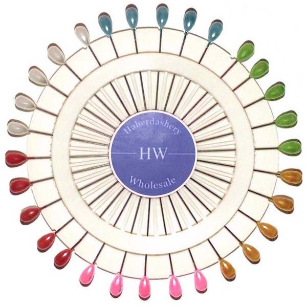 A wheel of extra long pearlised teardrop headed pins with 5 each of green, blue, white, red, pink and gold coloured head pins